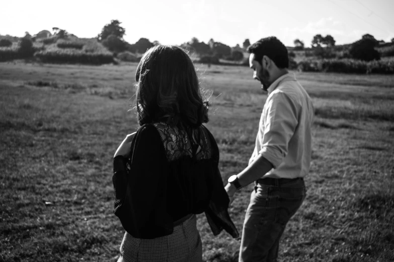 black and white po of two people in a field