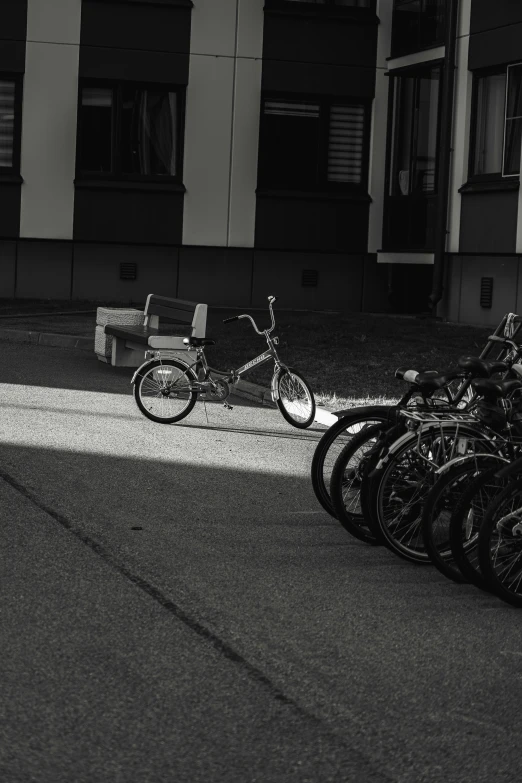 a row of bicycles are parked in front of a bench