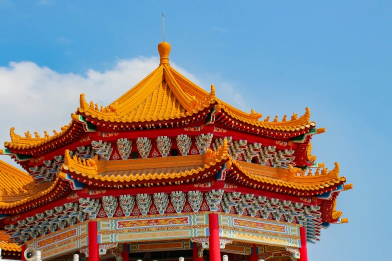 a pagoda with gold colored decoration on top