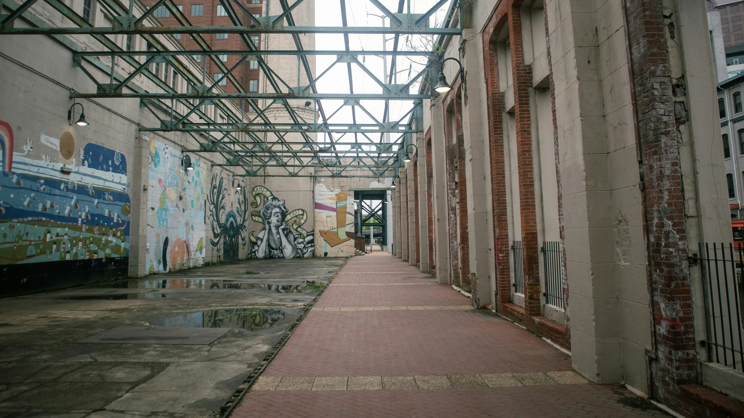 a hallway with many different graffitis on the walls