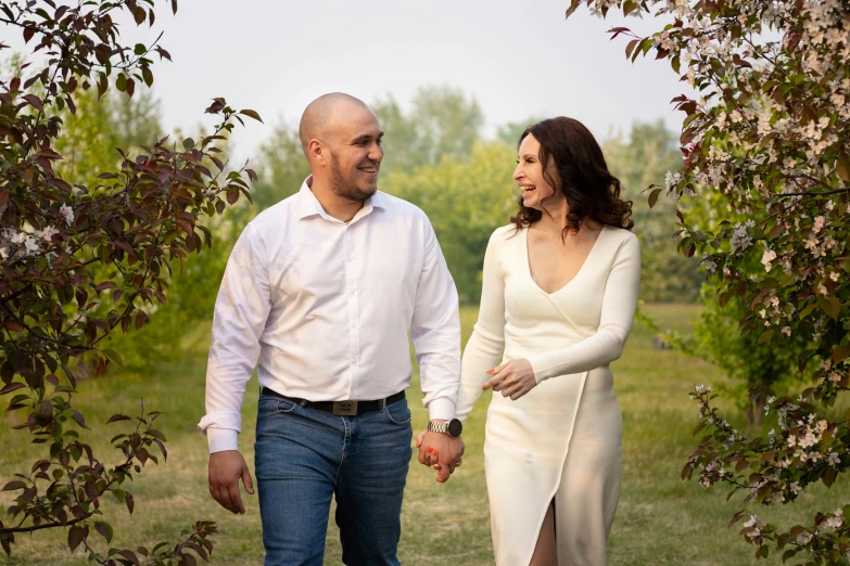 a young couple hold hands during a portrait session