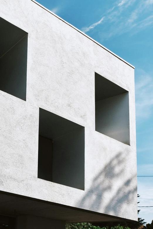 the building is made out of concrete and has square windows