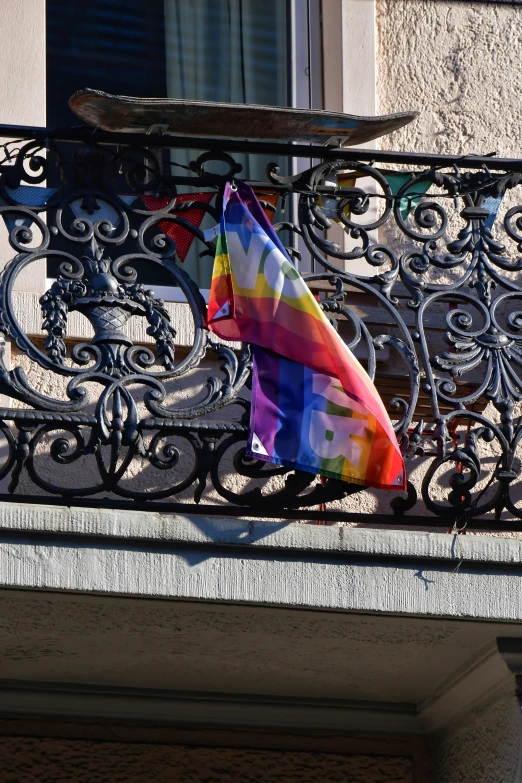 a colorful kite laying on a balcony rail