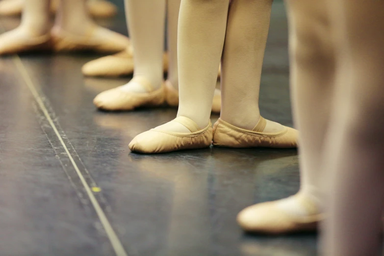 the back side of ballet legs in a row