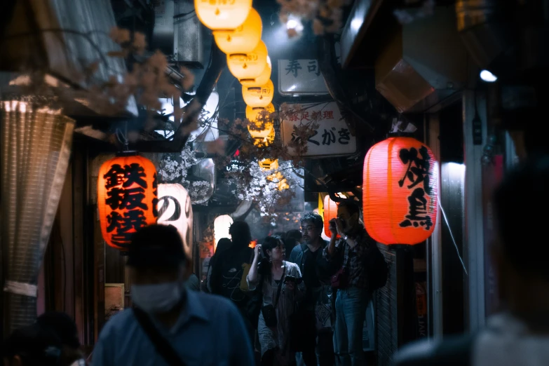 people walking on a narrow alley at night