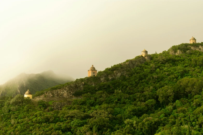 a green hillside on which a castle is situated