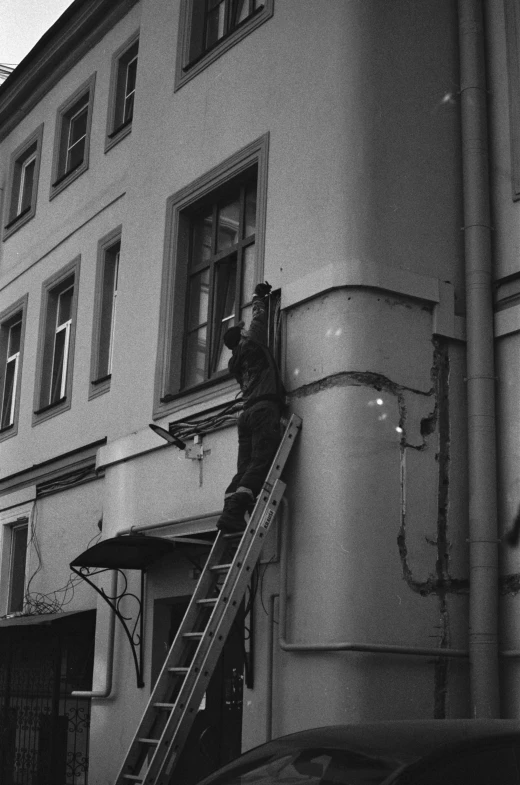 a man working on the side of a building