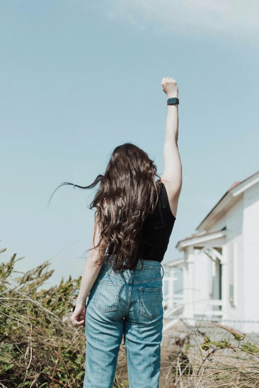 a woman standing outside in front of a house