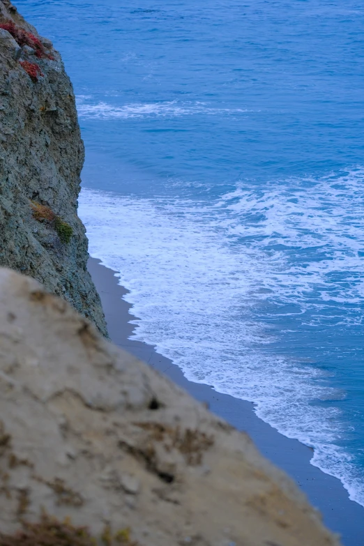 a body of water near the ocean, with a mountain side