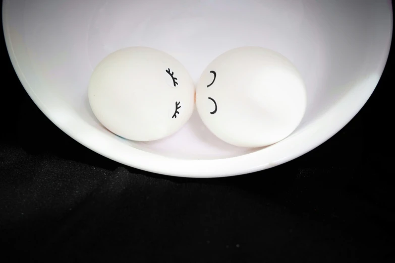 two eggs are sitting in a bowl of water