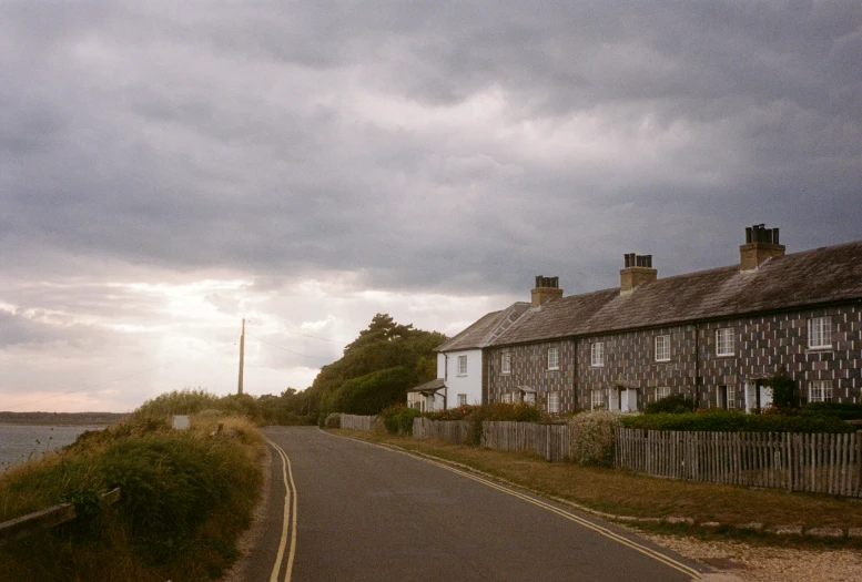 an image of a deserted road with houses in the background