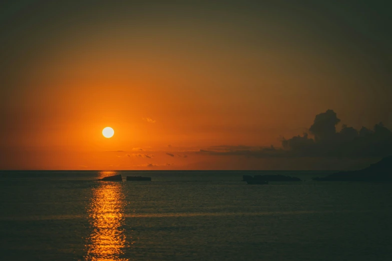 a boat is sailing into the sunset or sunrise