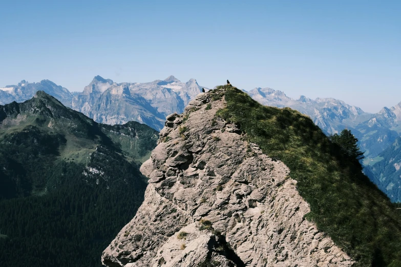 a large rock formation surrounded by mountains