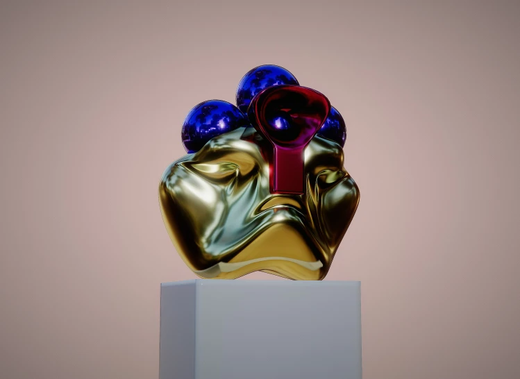 a gold and red sculpture with an evil mask on it