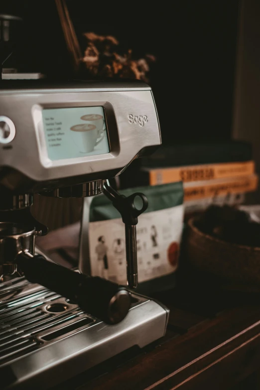 an espresso machine with a digital display sitting on top of it