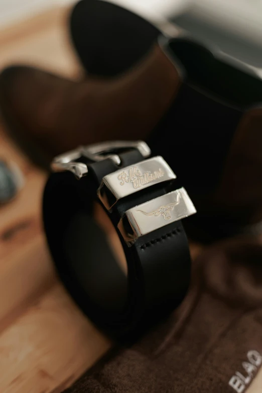 a black strap that has a square buckle on it