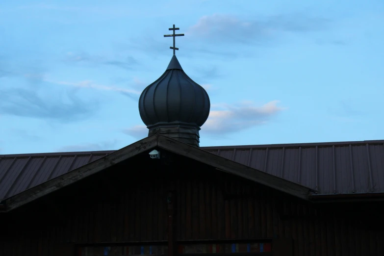 the cross is on top of the steeple of a building