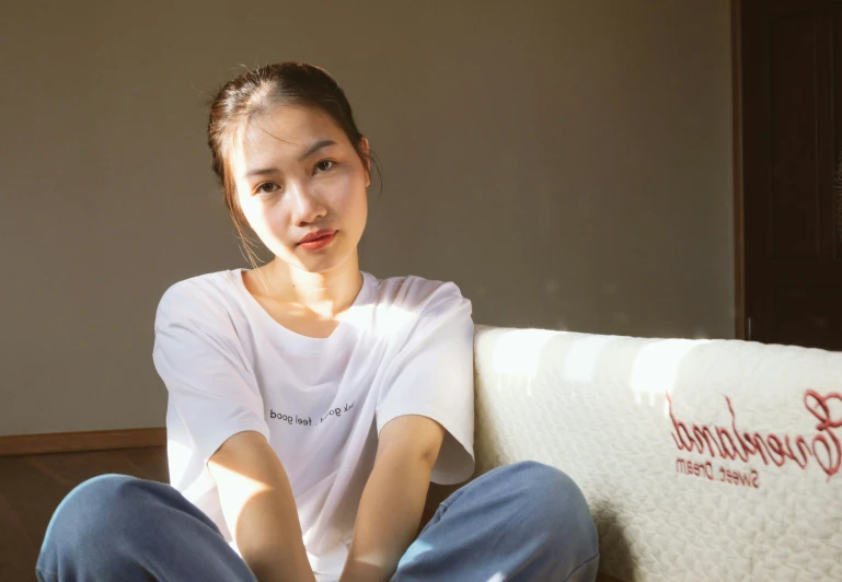 a woman sitting on the edge of a bed