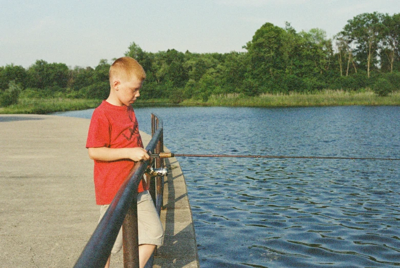 a  is fishing from a pier