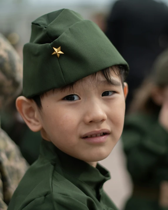 a boy in a military uniform looking at soing