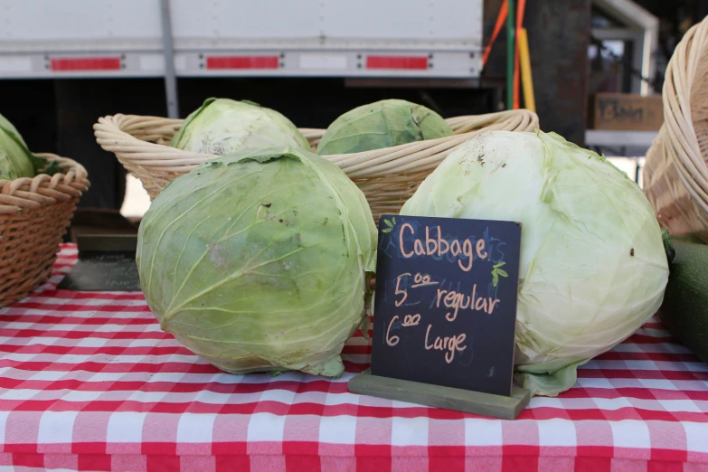 cabbage heads on display at a farmer's market