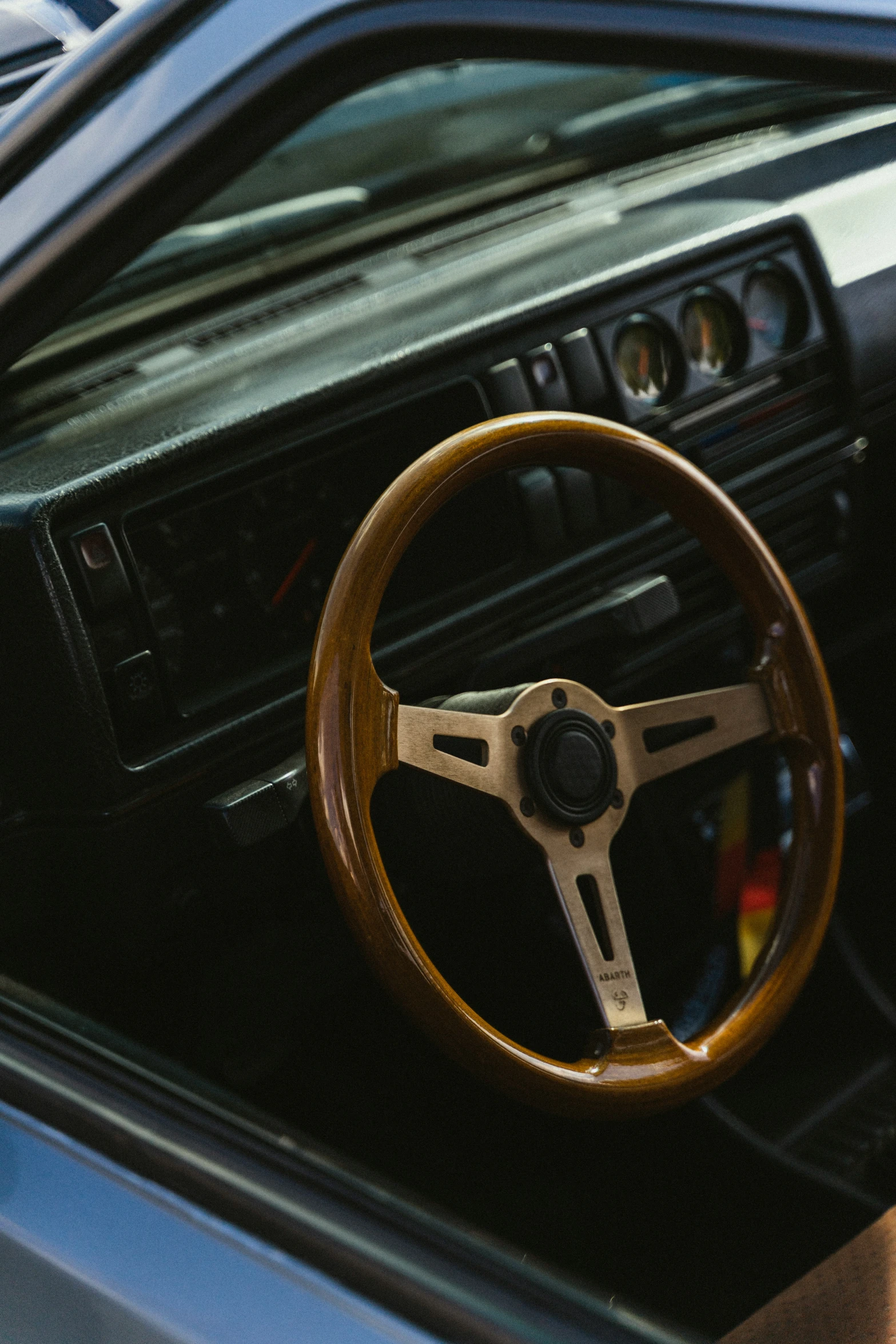 an old fashioned car dashboard with a steering wheel and dash light