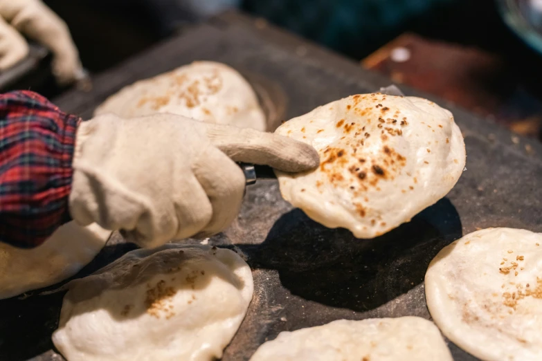 an old man is holding up some tortilla