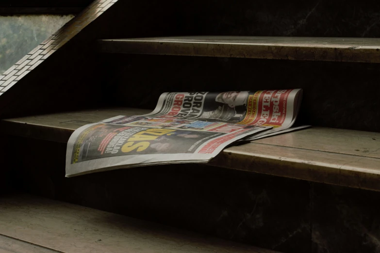 a news paper resting on the steps of an old building