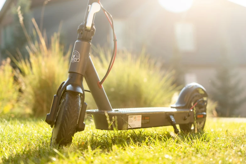 an electric scooter parked on a lawn next to a house