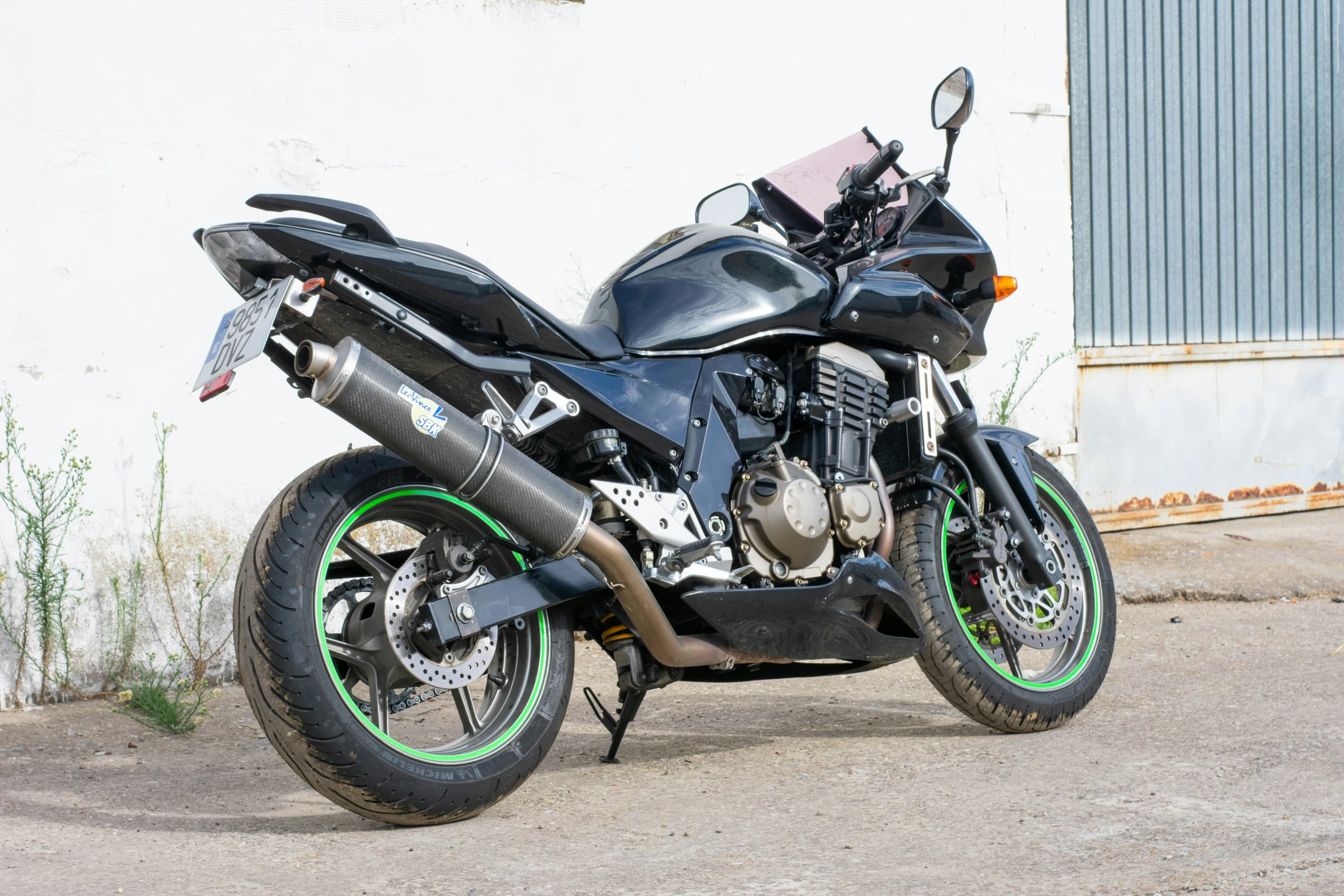 a black motorcycle with green and white rims