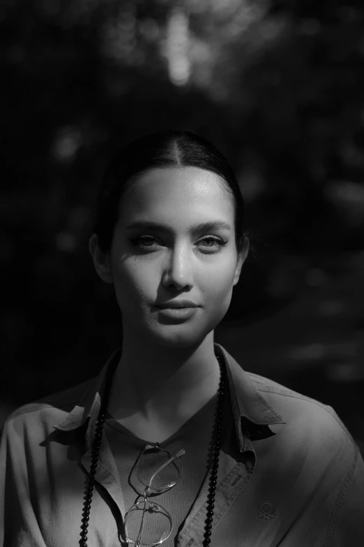 woman in shirt posing for black and white po