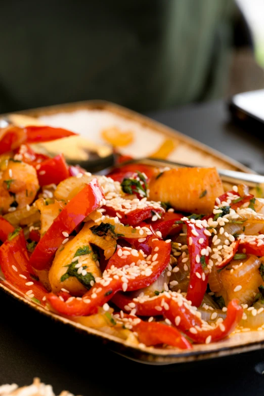 the tray has rice, vegetables and sesame seeds