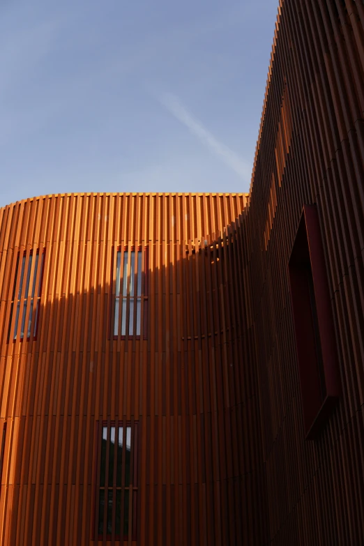 an orange colored building with a clock in the window