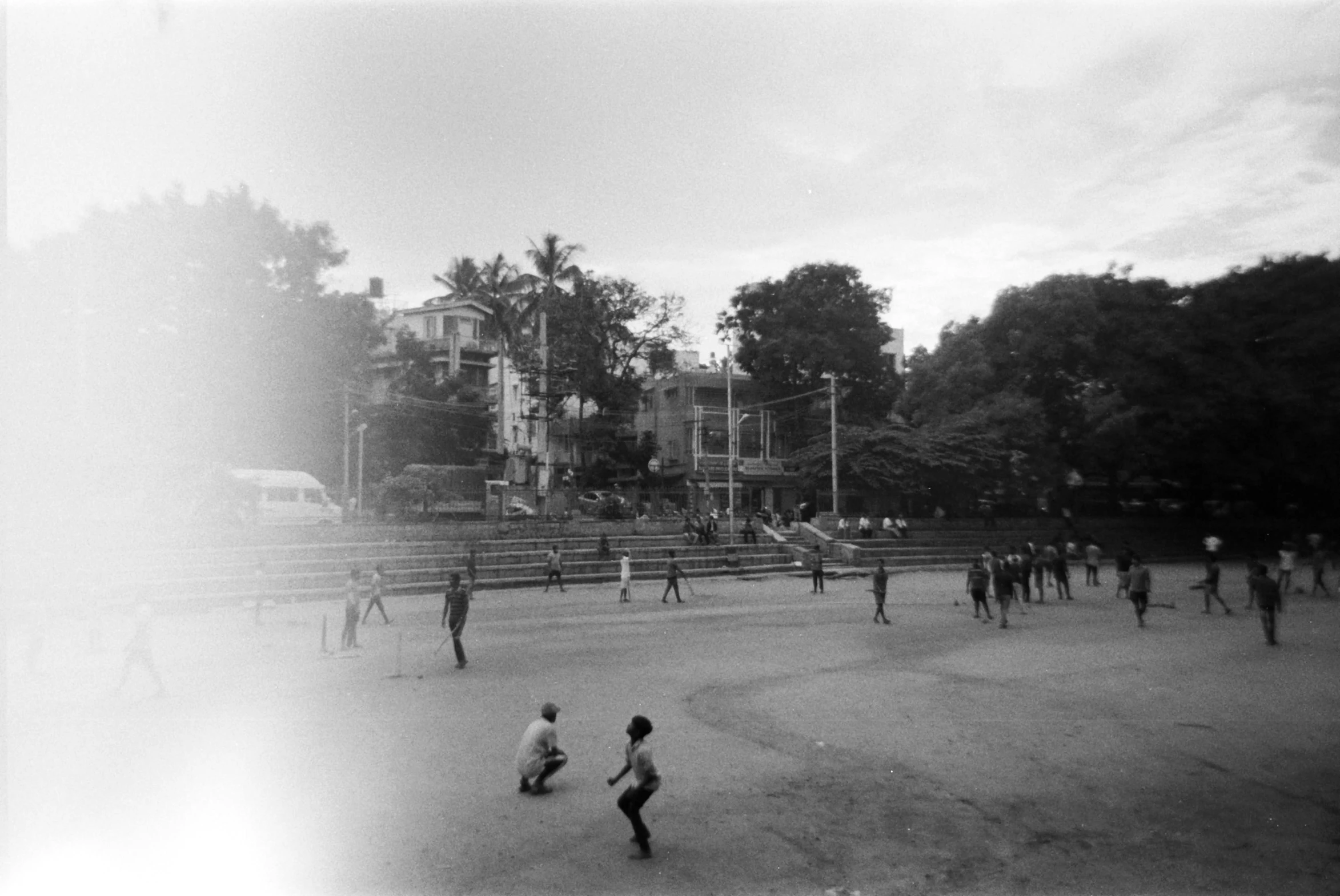 people are playing soccer outside on a foggy day