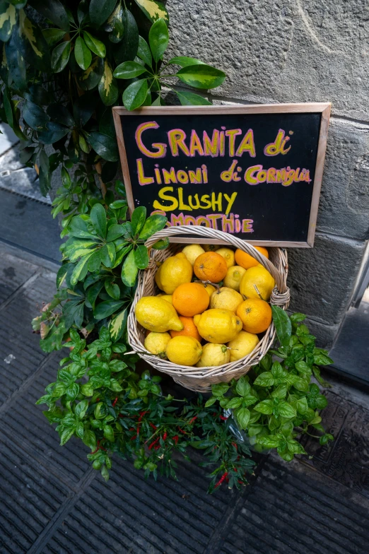 a pile of fresh fruit sitting under a sign