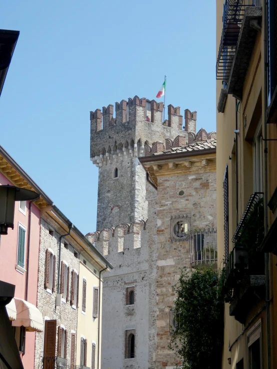 some old buildings in the back of a large castle