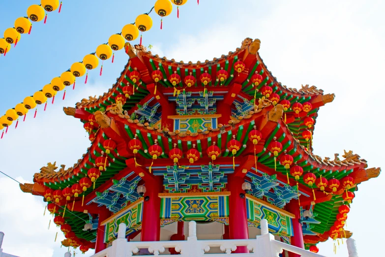 a tall building with lanterns hanging in the sky