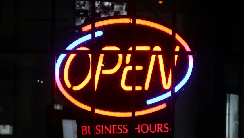 an open business hours sign with neon light