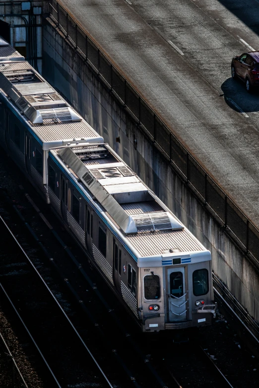 a train is on tracks and sitting by the wall