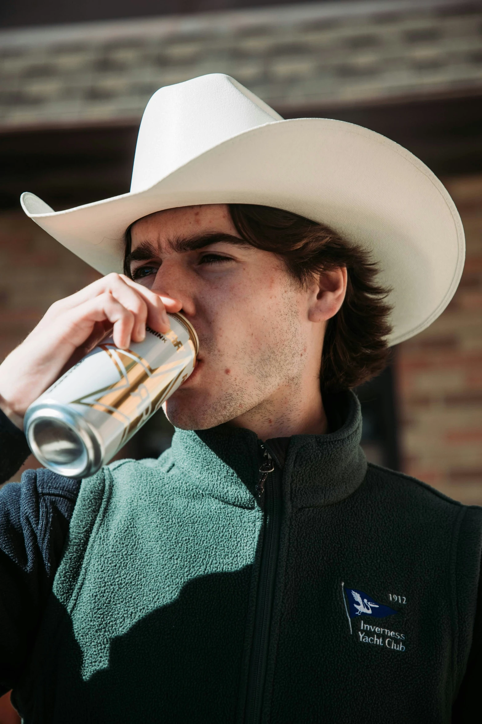 the cowboy is sipping from his coffee cup