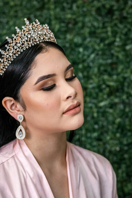 a woman with black hair wearing a tiara