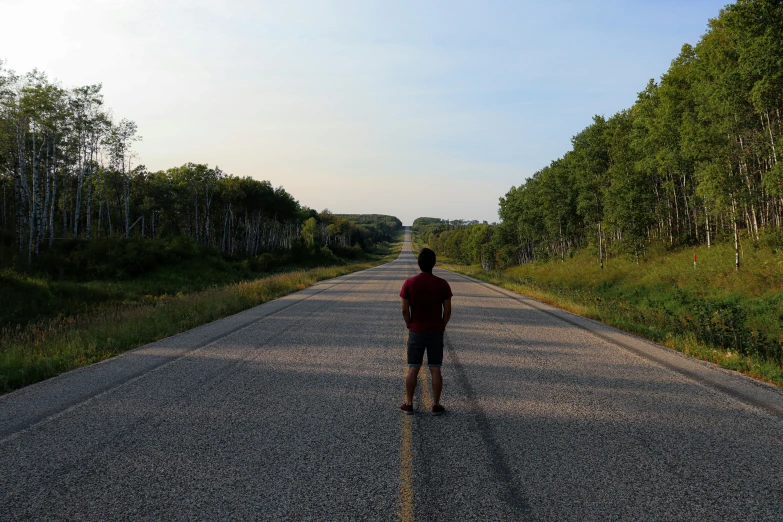 the person is standing alone along the road