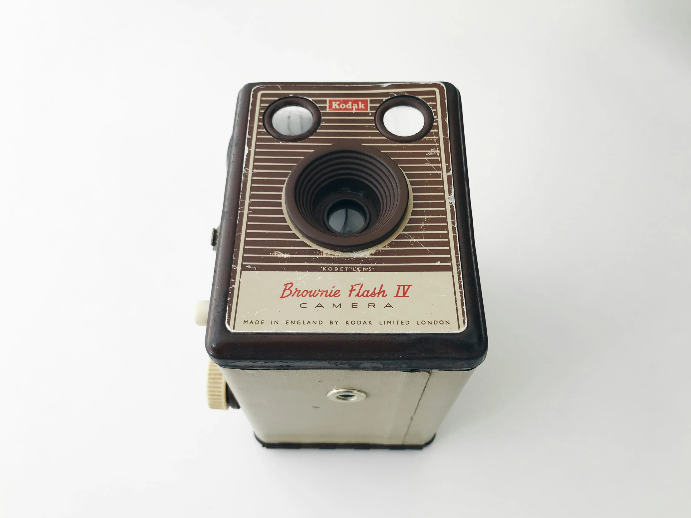 a small brown analog camera with three on controls