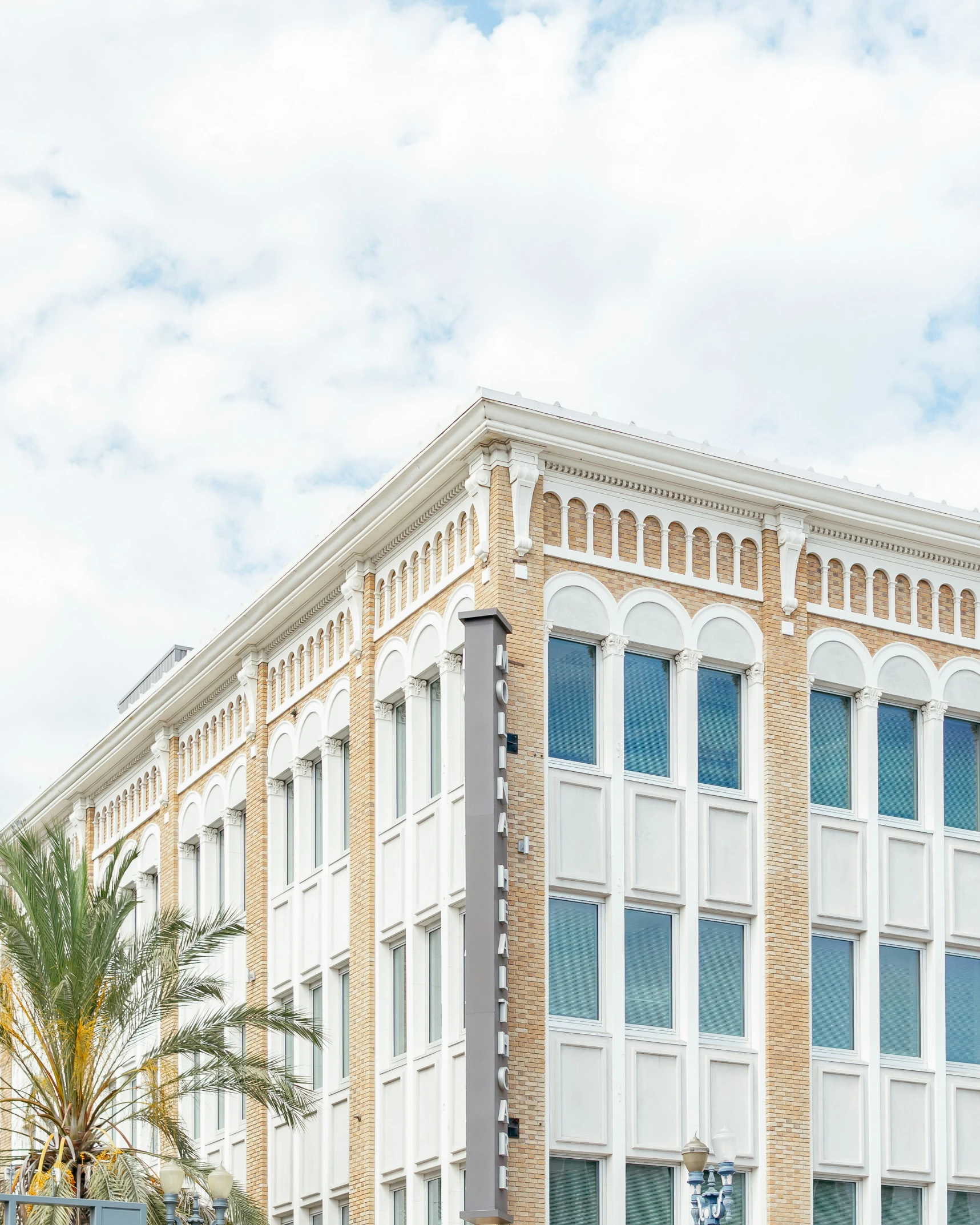 a building with trees and palm on the side