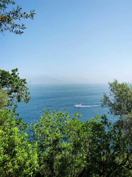 a boat is sailing along a scenic ocean view