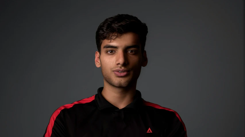 a man posing for the camera in a dark shirt