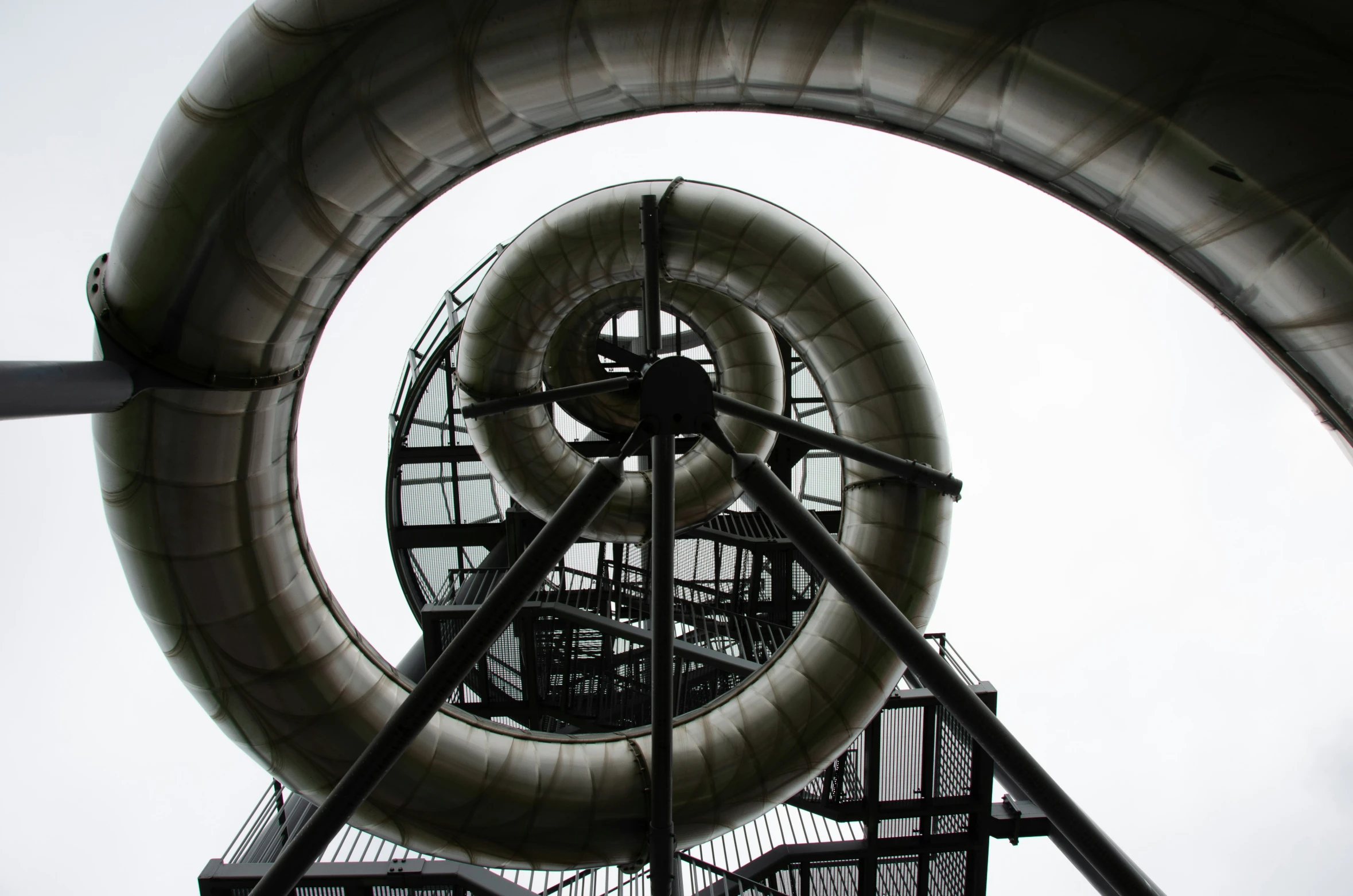 a round sculpture with a giant metal ring attached to it