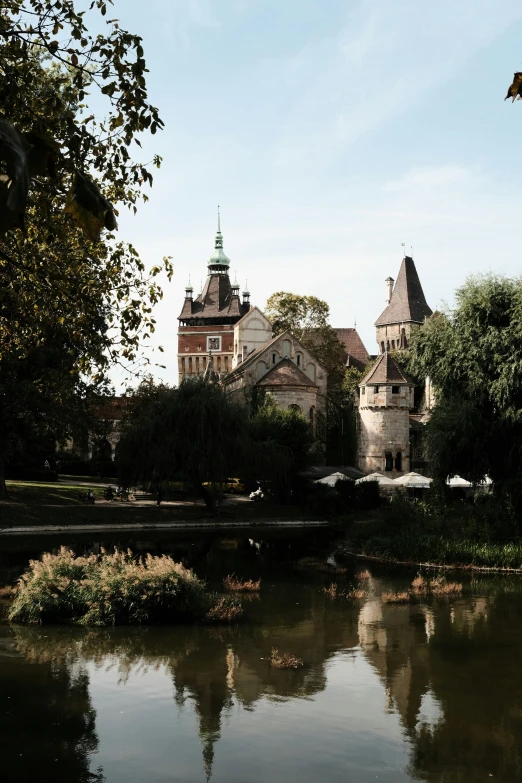 the water is calm in front of an elaborate castle