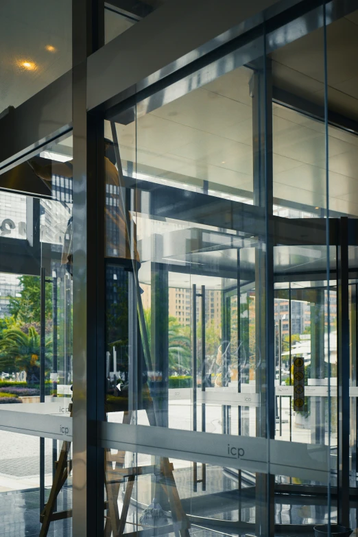 a building that is glass looking through the doors