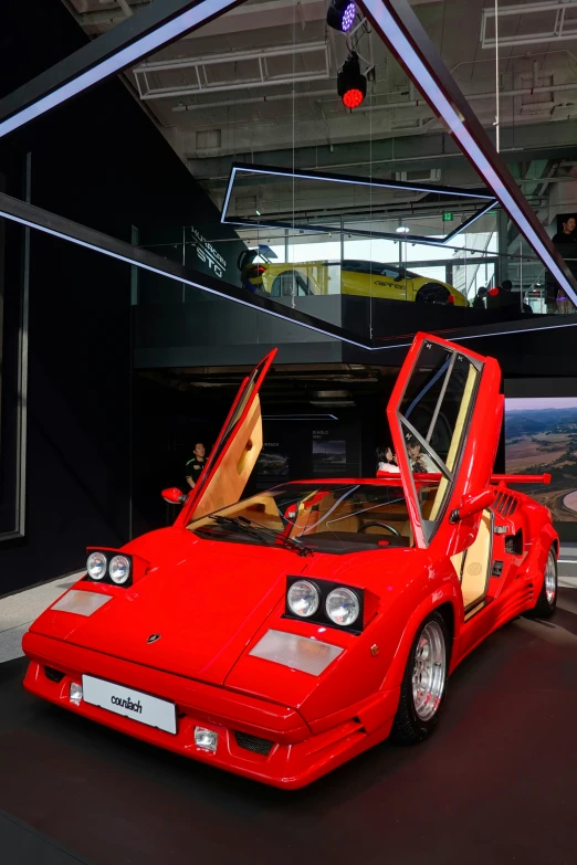 a bright red sports car is parked in the dark